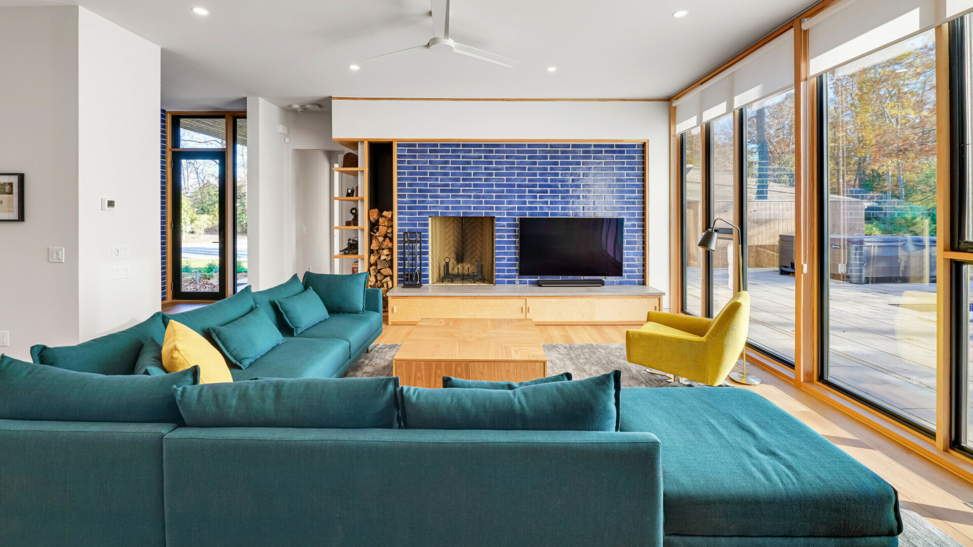 Great room boasting a custom blue mosaic tile wall with a fireplace, Rehoboth Beach DE