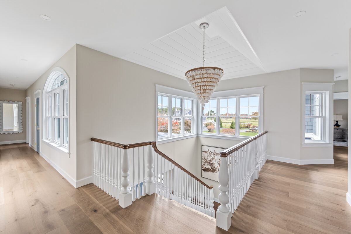Open living and dining room with water views in a Angola by the Bay custom home