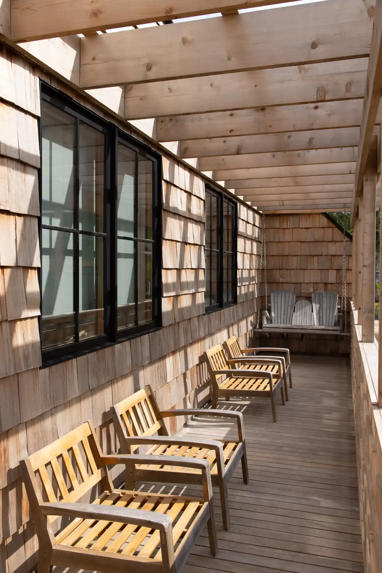 Screened cedar porch at a Bay Pines coastal home near the water