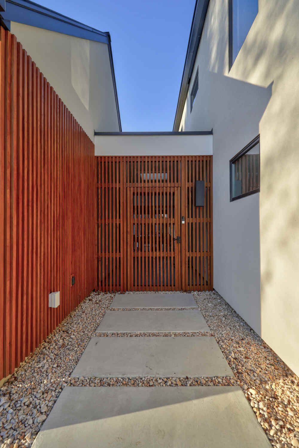 Screened cedar porch at a Bay Harbor coastal home near the water