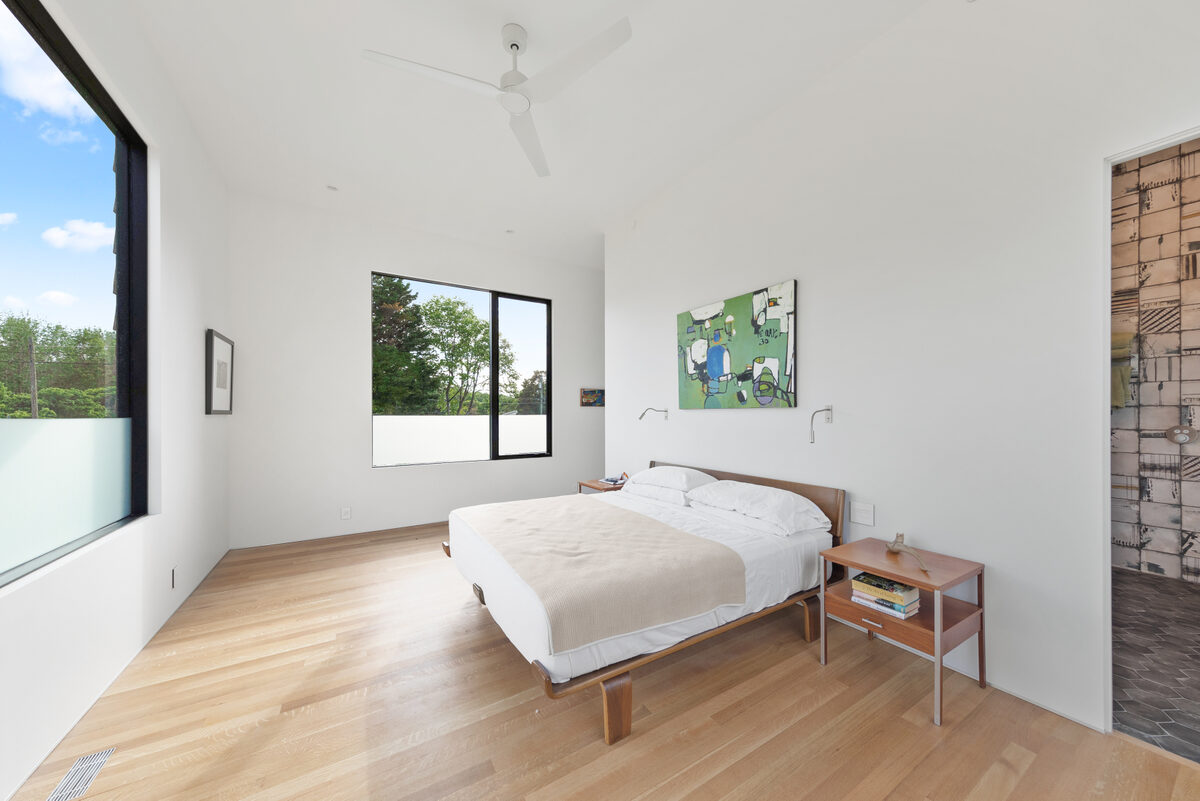 Open living and dining room with water views in a Breakwater custom home