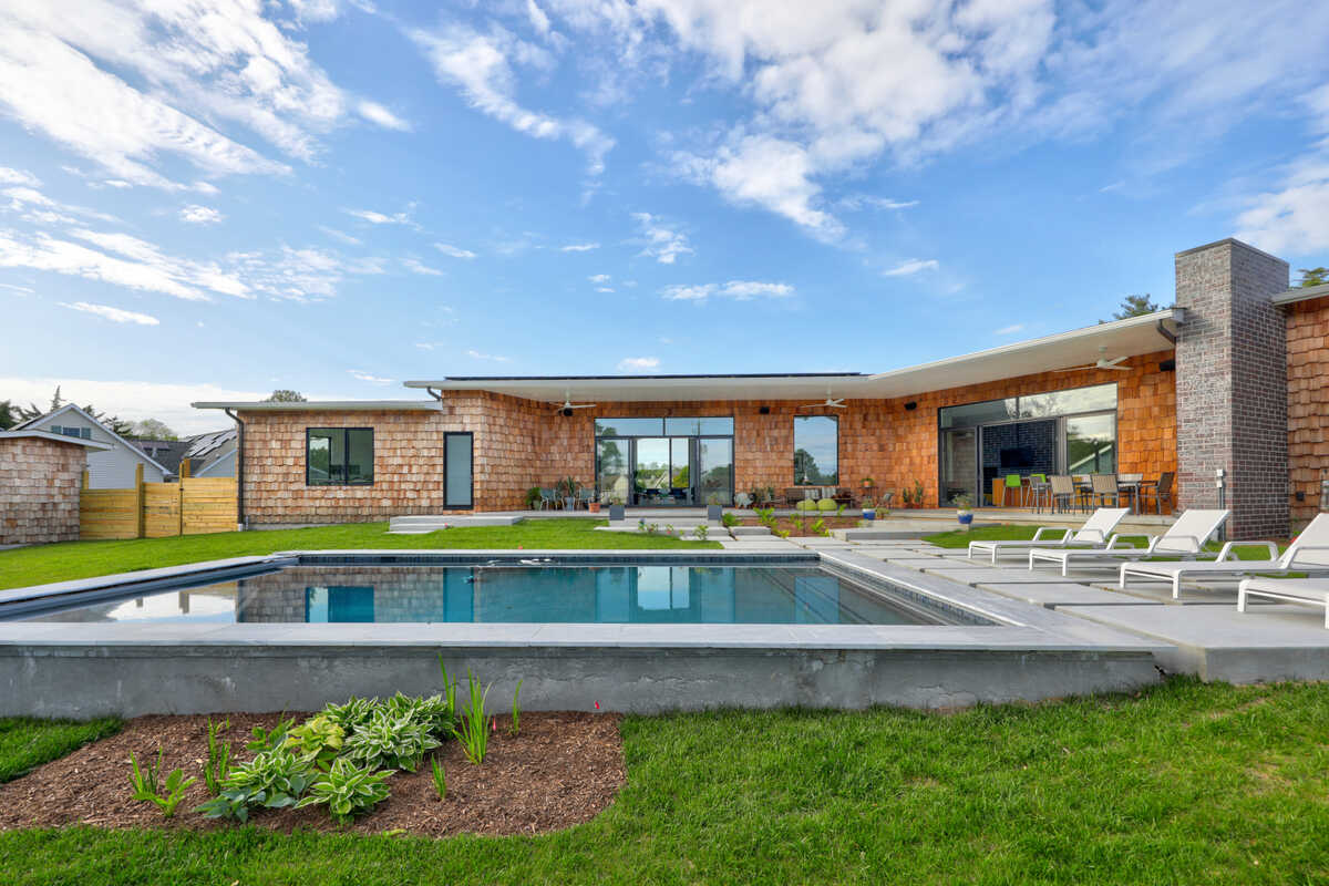 Covered deck and outdoor living at a Breakwater coastal home