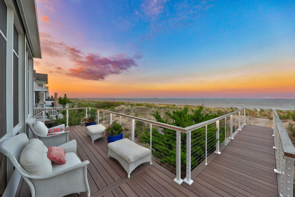 Coastal custom home exterior in Rehoboth by the Sea showing its lot and setting