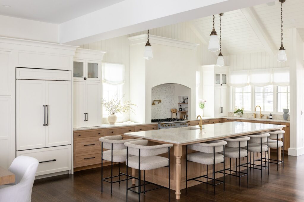 Coastal kitchen with a white oak island, marble countertop and arched range alcove in a CRx Construction home in Dewey Beach, Delaware