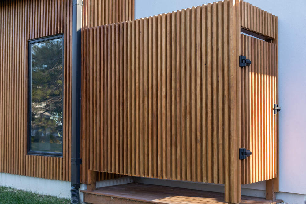 Screened cedar porch at a Henlopen Landing coastal home near the water
