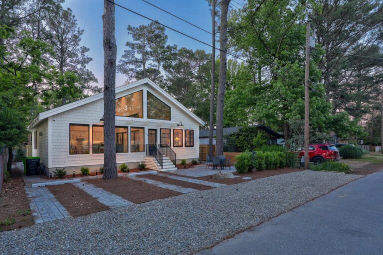 Renovated coastal cottage at twilight after a home remodeling project in Dewey Beach by CRx Construction