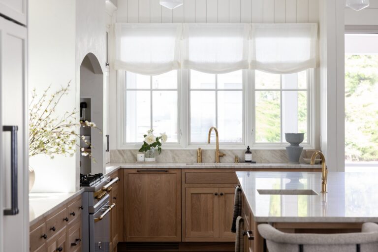 Renovated coastal kitchen with white oak cabinetry and marble counters in a Dewey Beach home by CRx Construction